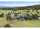 Expansive estate on a verdant lot featuring mature trees, long driveway, and mountain views at 32399 Woodland Dr, Evergreen, CO 80439