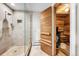 Modern bathroom featuring a glass shower and a classic wooden sauna at 32399 Woodland Dr, Evergreen, CO 80439