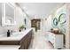 Bright bathroom with double vanity, stone accent wall, and updated fixtures at 32399 Woodland Dr, Evergreen, CO 80439
