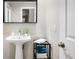 Bright bathroom features pedestal sink with a framed mirror at 32399 Woodland Dr, Evergreen, CO 80439