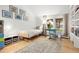 Bright bedroom features a bed, desk and chair next to large windows with a view at 32399 Woodland Dr, Evergreen, CO 80439
