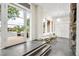 Open-concept foyer with white wooden paneling and tile floors, providing natural light at 32399 Woodland Dr, Evergreen, CO 80439