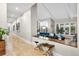 Long hallway leading to a living space with vaulted ceilings and beautiful backyard views at 32399 Woodland Dr, Evergreen, CO 80439