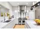 Modern kitchen featuring stainless steel appliances, white cabinets, and hardwood floors at 32399 Woodland Dr, Evergreen, CO 80439