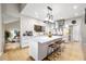Spacious kitchen with stainless steel appliances, a large island with bar stools, and hardwood floors at 32399 Woodland Dr, Evergreen, CO 80439