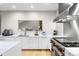 Modern kitchen with stainless steel oven, white cabinets, and hardwood floors at 32399 Woodland Dr, Evergreen, CO 80439