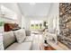 Bright living room with vaulted ceilings, stone fireplace, and access to the outdoor space at 32399 Woodland Dr, Evergreen, CO 80439