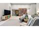 Open-concept living area with bookshelves, fireplace, and comfortable seating at 32399 Woodland Dr, Evergreen, CO 80439