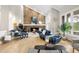 Spacious living room with stone fireplace, hardwood floors, and comfortable modern seating at 32399 Woodland Dr, Evergreen, CO 80439