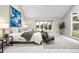 Bright main bedroom with artwork and window seating overlooking the beautiful landscape at 32399 Woodland Dr, Evergreen, CO 80439