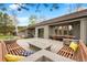 Enjoy this outdoor patio with a glass fireplace, built in benches, dining table and views of the property at 32399 Woodland Dr, Evergreen, CO 80439