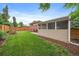 Large fenced backyard features a concrete patio and a screened-in porch at 6011 Welch St, Arvada, CO 80004