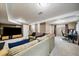 Spacious finished basement with carpet, a TV and entertainment center, and an office area at 6011 Welch St, Arvada, CO 80004