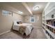 Basement bedroom with bright built-in shelving unit and lots of natural light at 6011 Welch St, Arvada, CO 80004