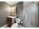 Updated bathroom featuring a new vanity, toilet, and a glass-enclosed shower at 6011 Welch St, Arvada, CO 80004