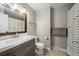Neutral bathroom featuring a modern vanity, mirror, and decorative fish shower curtain at 6011 Welch St, Arvada, CO 80004