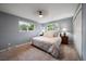 Bright bedroom featuring two large windows, carpet flooring, and neutral paint colors at 6011 Welch St, Arvada, CO 80004