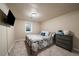 Bedroom boasts a queen bed with a metal frame, patterned coverlet, and a wall-mounted TV at 6011 Welch St, Arvada, CO 80004