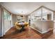 Stylish dining room with hardwood floors, neutral paint, and modern lighting fixture at 6011 Welch St, Arvada, CO 80004