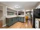 Updated kitchen featuring custom cabinets, granite countertops, and stainless steel appliances at 6011 Welch St, Arvada, CO 80004