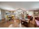 Spacious living room with dining area and open view to the modern kitchen at 6011 Welch St, Arvada, CO 80004
