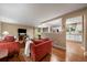 Inviting living room with hardwood floors, neutral paint, and an open view to kitchen at 6011 Welch St, Arvada, CO 80004