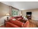 Bright living room with hardwood floors, large window, and a comfortable seating arrangement at 6011 Welch St, Arvada, CO 80004