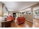 Comfortable living room featuring wood floors, bright windows, and a cozy seating area at 6011 Welch St, Arvada, CO 80004