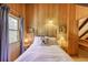 Cozy bedroom with wood paneled walls, vintage decor, and a comfortable bed with a 'Ski Colorado' throw pillow at 29 Gregory Cir, Breckenridge, CO 80424