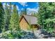 Charming log cabin nestled amongst trees, featuring a durable metal roof, and serene, natural surroundings at 29 Gregory Cir, Breckenridge, CO 80424