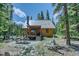 Cozy cabin exterior featuring a porch, picnic table, and peaceful wooded setting at 29 Gregory Cir, Breckenridge, CO 80424