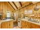 Galley-style kitchen with wooden cabinets, white appliances, and an adjacent dining area at 29 Gregory Cir, Breckenridge, CO 80424