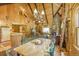 Charming living area featuring a stone fireplace, wooden beams and vaulted ceilings at 29 Gregory Cir, Breckenridge, CO 80424