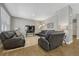 Living room with leather couches, hardwood floors, and view of kitchen at 868 N Quatar St, Aurora, CO 80018