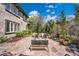 Landscaped backyard featuring a flagstone patio, outdoor seating, and mature trees at 2616 E Cherry Creek South Dr, Denver, CO 80209