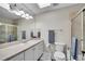 Bathroom with neutral color scheme, wide mirror, shower with glass door, and white cabinets at 2616 E Cherry Creek South Dr, Denver, CO 80209
