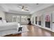 Well-lit bedroom featuring hardwood floors, large windows, and french doors at 2616 E Cherry Creek South Dr, Denver, CO 80209