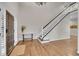 Bright foyer with hardwood floors, a staircase, and natural light creates a welcoming entrance at 2616 E Cherry Creek South Dr, Denver, CO 80209