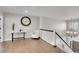 Bright hallway with hardwood floors, stylish console table, and a decorative wall clock at 2616 E Cherry Creek South Dr, Denver, CO 80209