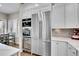 Kitchen features stainless appliances, white cabinetry, and a wine fridge at 2616 E Cherry Creek South Dr, Denver, CO 80209