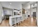 Open kitchen boasts white cabinets, stainless steel appliances, and a large center island with seating at 2616 E Cherry Creek South Dr, Denver, CO 80209