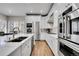Open kitchen with white cabinets, stainless appliances, and large island offers style and functionality at 2616 E Cherry Creek South Dr, Denver, CO 80209