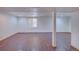 Finished basement with wooden floors, neutral walls, and recessed lighting at 5723 Zephyr St, Arvada, CO 80002