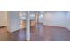 Open basement area with hardwood floors and partial view of a kitchen at 5723 Zephyr St, Arvada, CO 80002