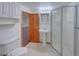 This bathroom features a shower, pedestal sink, and medicine cabinet at 5723 Zephyr St, Arvada, CO 80002
