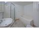Bathroom featuring an oversized tub, separate shower, and vanity at 5723 Zephyr St, Arvada, CO 80002