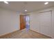 Bedroom with neutral carpet, closet, and view to the kitchen at 5723 Zephyr St, Arvada, CO 80002