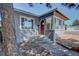 Charming home featuring a red front door and a cozy sunroom at 5723 Zephyr St, Arvada, CO 80002