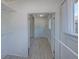 Bright hallway featuring neutral walls, light flooring, and an archway leading to another room at 5723 Zephyr St, Arvada, CO 80002