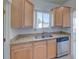 Kitchen showcasing stainless steel appliances, light wood cabinets and granite countertops at 5723 Zephyr St, Arvada, CO 80002